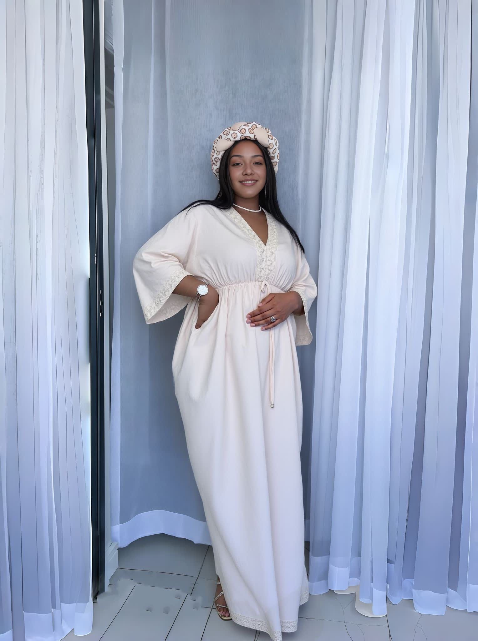 Cream maxi dress with V-neck and decorative buttons, wide sleeves and tied waist