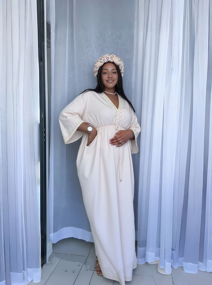 Cream maxi dress with V-neck and decorative buttons, wide sleeves and tied waist