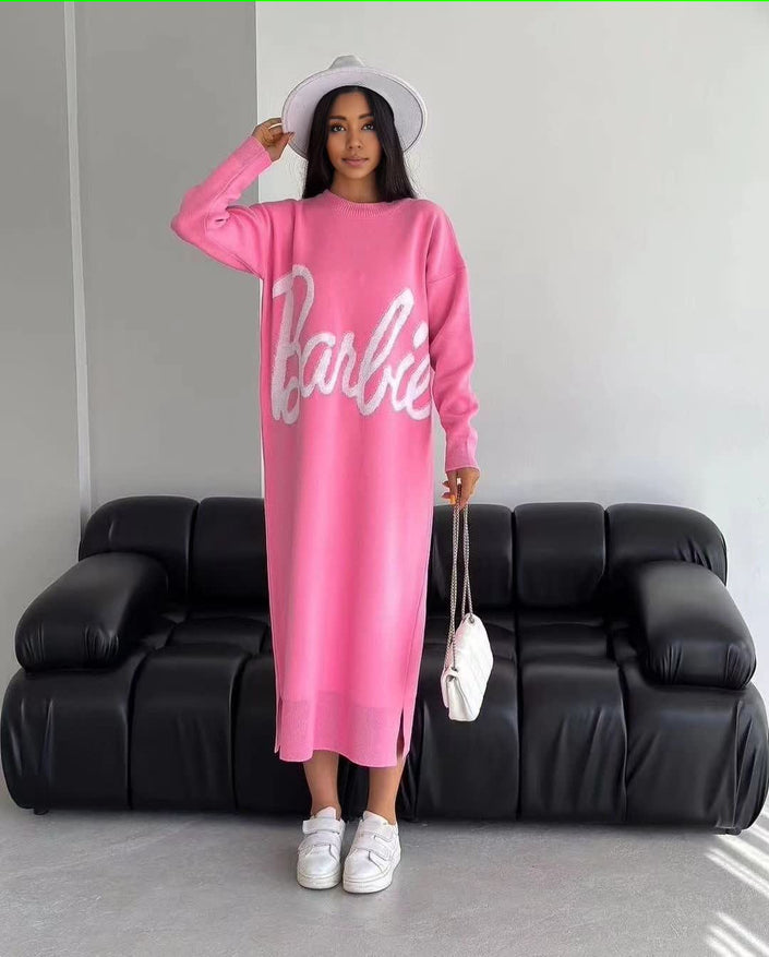 Pink knit maxi dress with long sleeves and white script logo front, crew neckline.