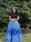 Blue pleated flared maxi skirt with patterned hem and border