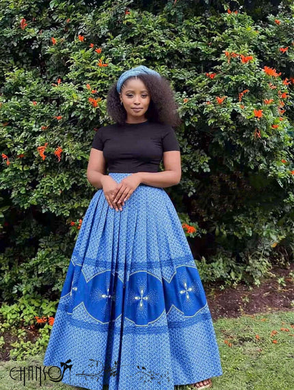 Blue pleated flared maxi skirt with patterned hem and border