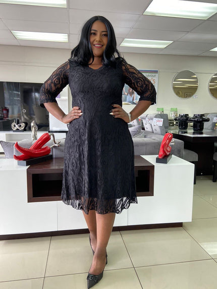 Black lace midi dress with 3/4 sleeves and floral overlay, flared skirt