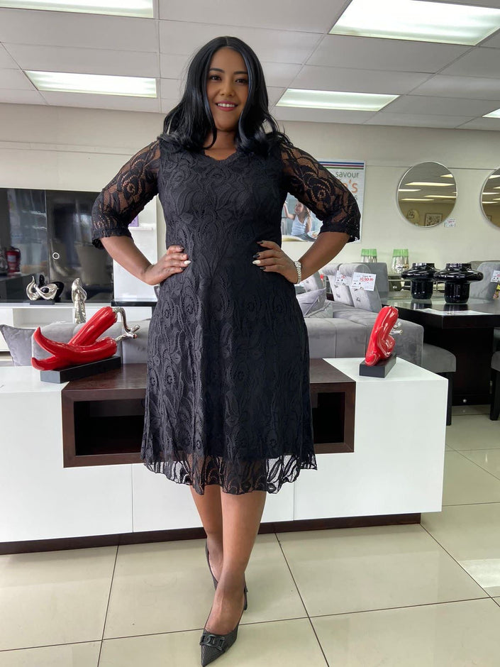 Black lace midi dress with 3/4 sleeves and floral overlay, flared skirt