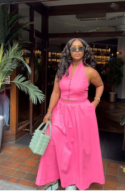 Hot-pink halter top and skirt set with fitted bodice and full midi skirt