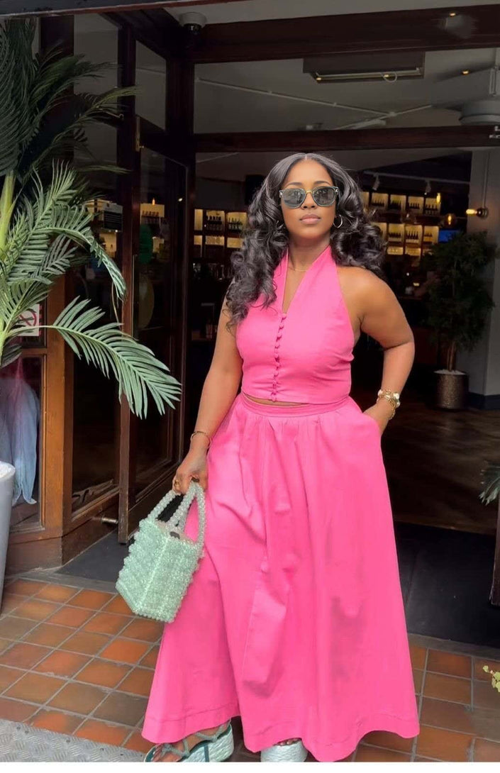 Hot-pink halter top and skirt set with fitted bodice and full midi skirt