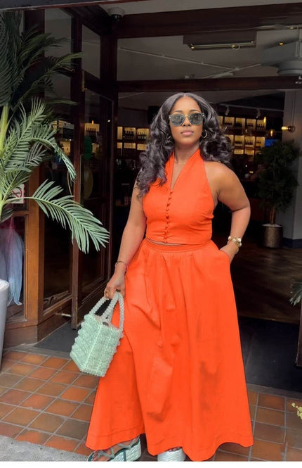 Orange-red halter top and skirt set with fitted bodice and full midi skirt