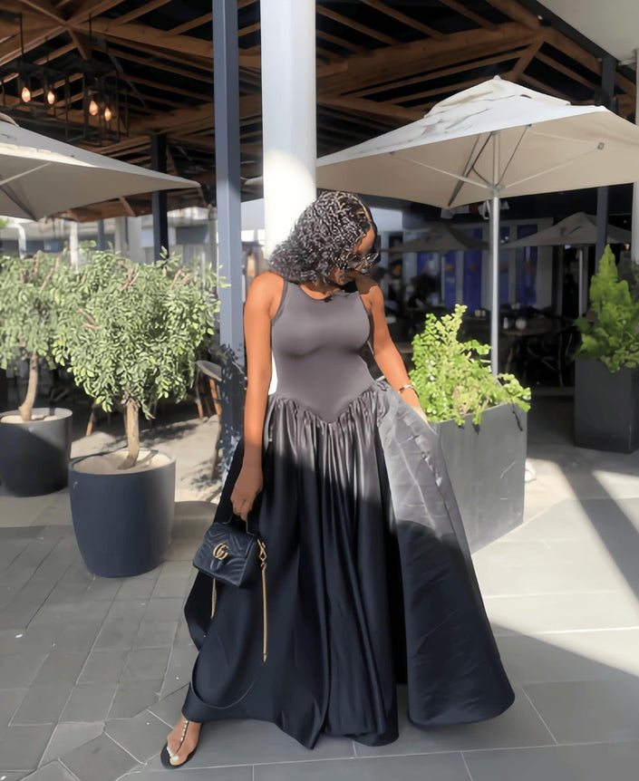 Dark gray maxi dress with fitted sleeveless bodice and gathered full skirt