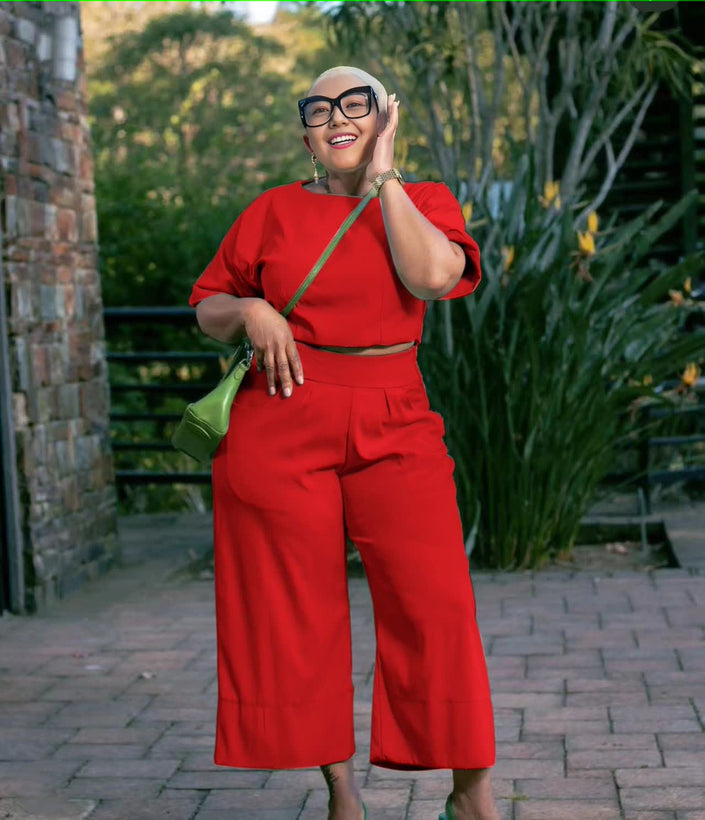 Red twin set top and wide-leg pants with short sleeves and contrast green belt