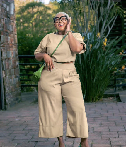 Beige twin set top and wide-leg pants with short sleeves and contrast green belt