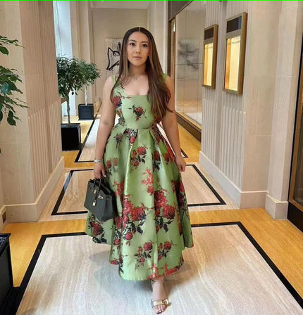 Green floral midi dress with adjustable spaghetti straps and fitted bodice