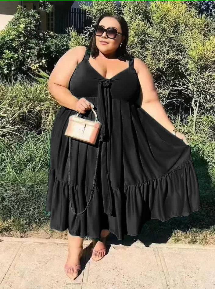 Plus size ruffle hem dress in black, sleeveless V-neck tie with tiered ruffle hem