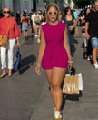 Sleeveless front-tie romper in fuchsia with buttoned bodice and tied waist detail