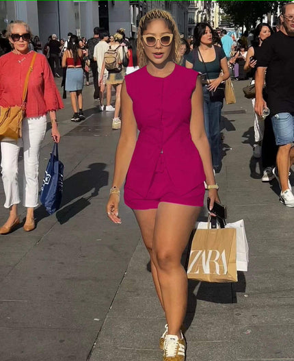Sleeveless front-tie romper in fuchsia with buttoned bodice and tied waist detail