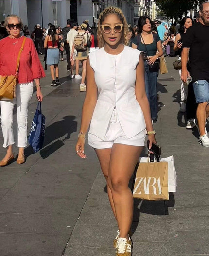 Sleeveless front-tie romper in white with buttoned bodice and drawstring waist