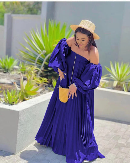 Off-shoulder pleated maxi dress, dark blue puff sleeves.