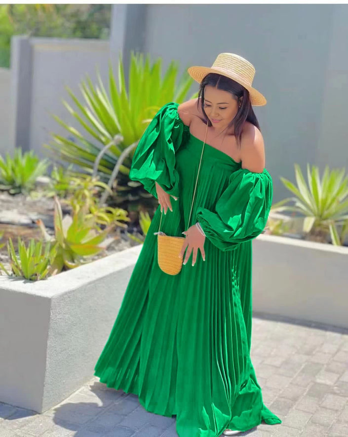 Off-shoulder pleated maxi dress, bright green puff sleeves.