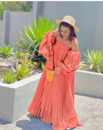 Off-shoulder pleated maxi dress, salmon pink puff sleeves.