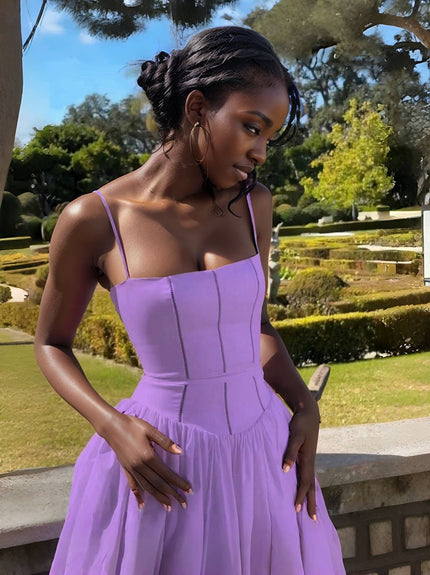 Light purple midi dress with thin straps, fitted bodice, and tiered skirt