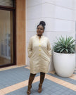 Cream/nude midi dress with long sleeves and five-button front, round neckline.