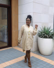 Nude/beige midi dress with long sleeves, five-button front, and round neckline.