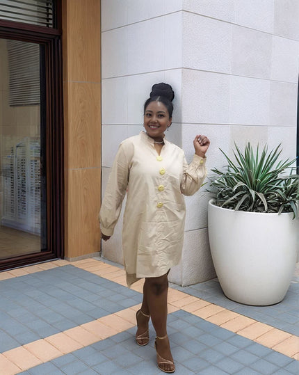 Nude/beige midi dress with long sleeves, five-button front, and round neckline.