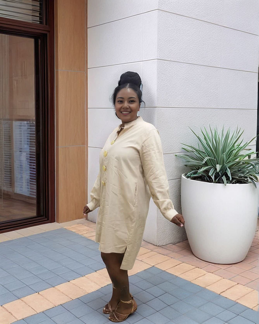 Nude/beige midi dress with long sleeves and five-button front, round neckline.