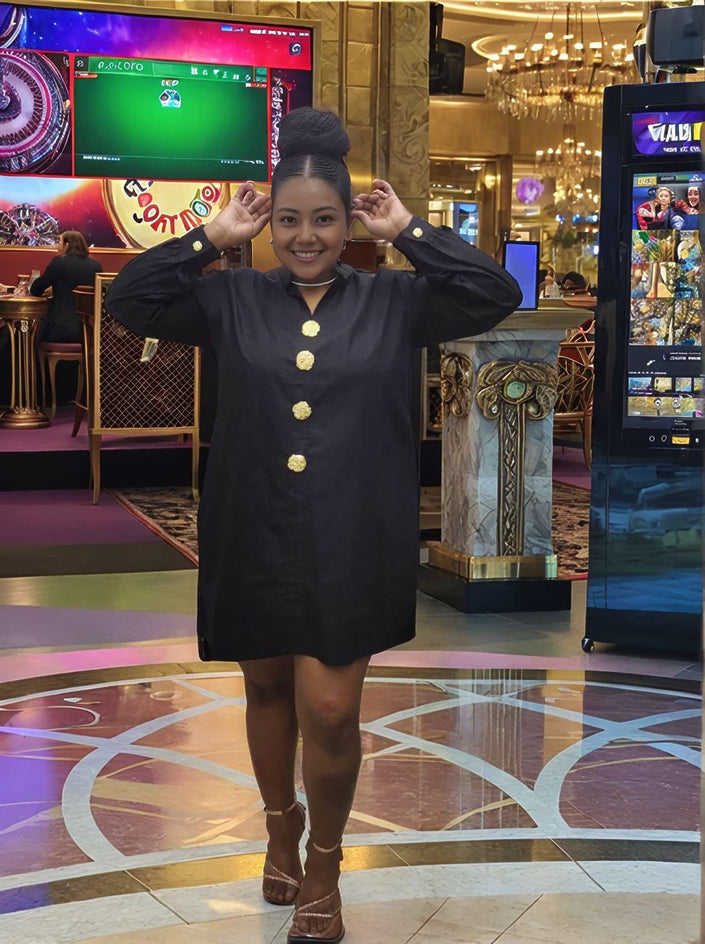 Black midi dress with long sleeves and five-button front with gold-tone buttons.