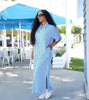 Collared striped midi dress with front slit, light sky-blue vertical stripes.
