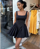 Black pleated skater dress with square neckline and gathered flared skirt