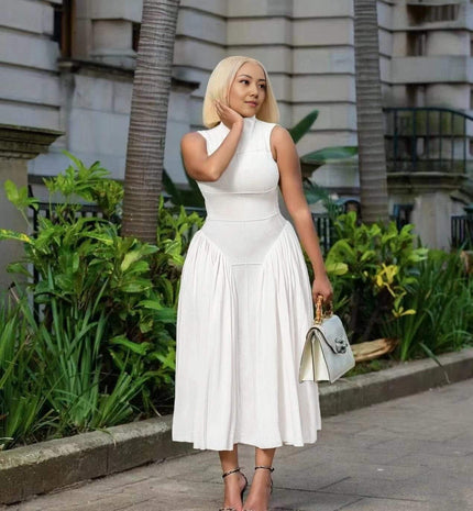 White pleated midi A-line dress, sleeveless high neckline, fitted waist to skirt
