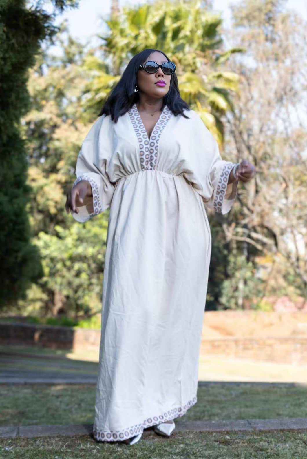 Geometric maxi dress, white with patterned yoke and trim along sleeve openings