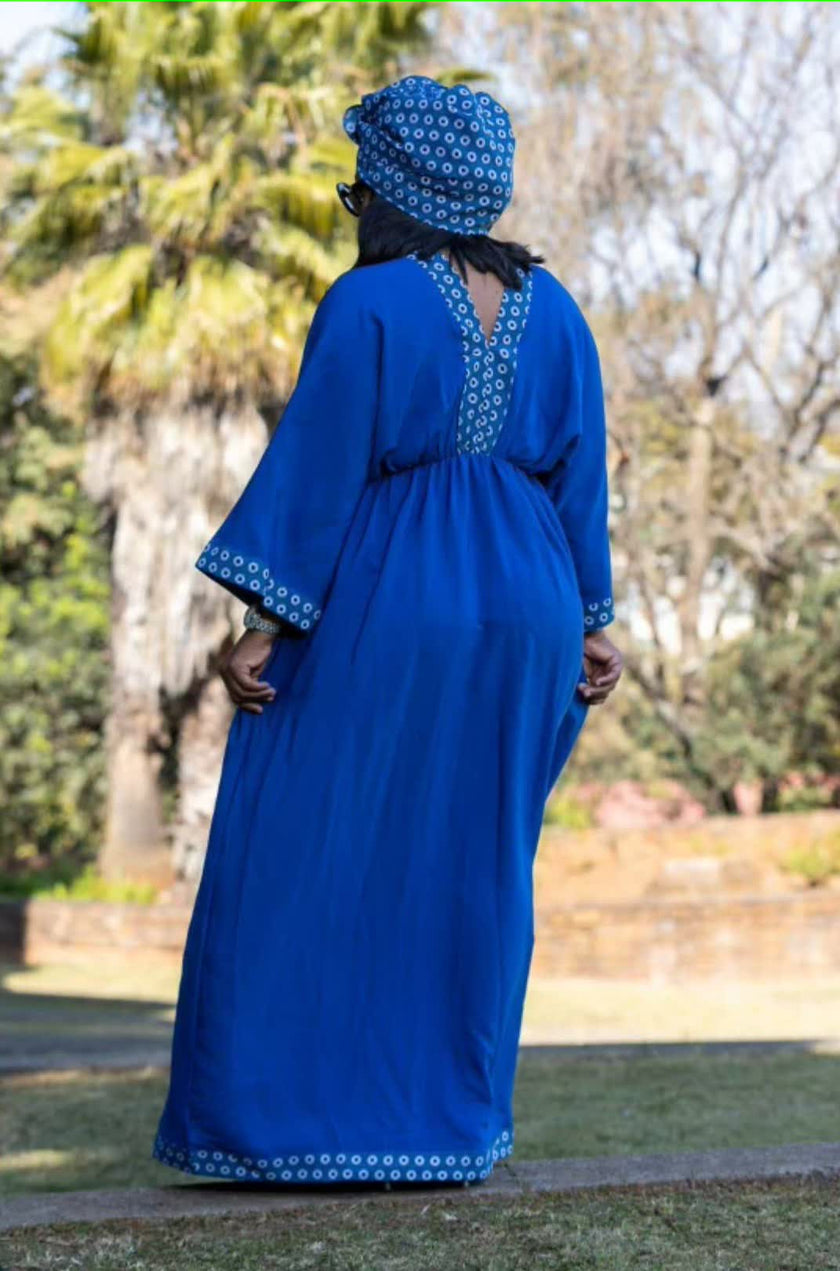 Blue geometric maxi dress, stretch waist seam and patterned hem trim (rear view)