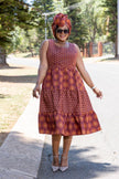 Ethnic tiered dress with geometric motifs, sleeveless; burgundy and orange