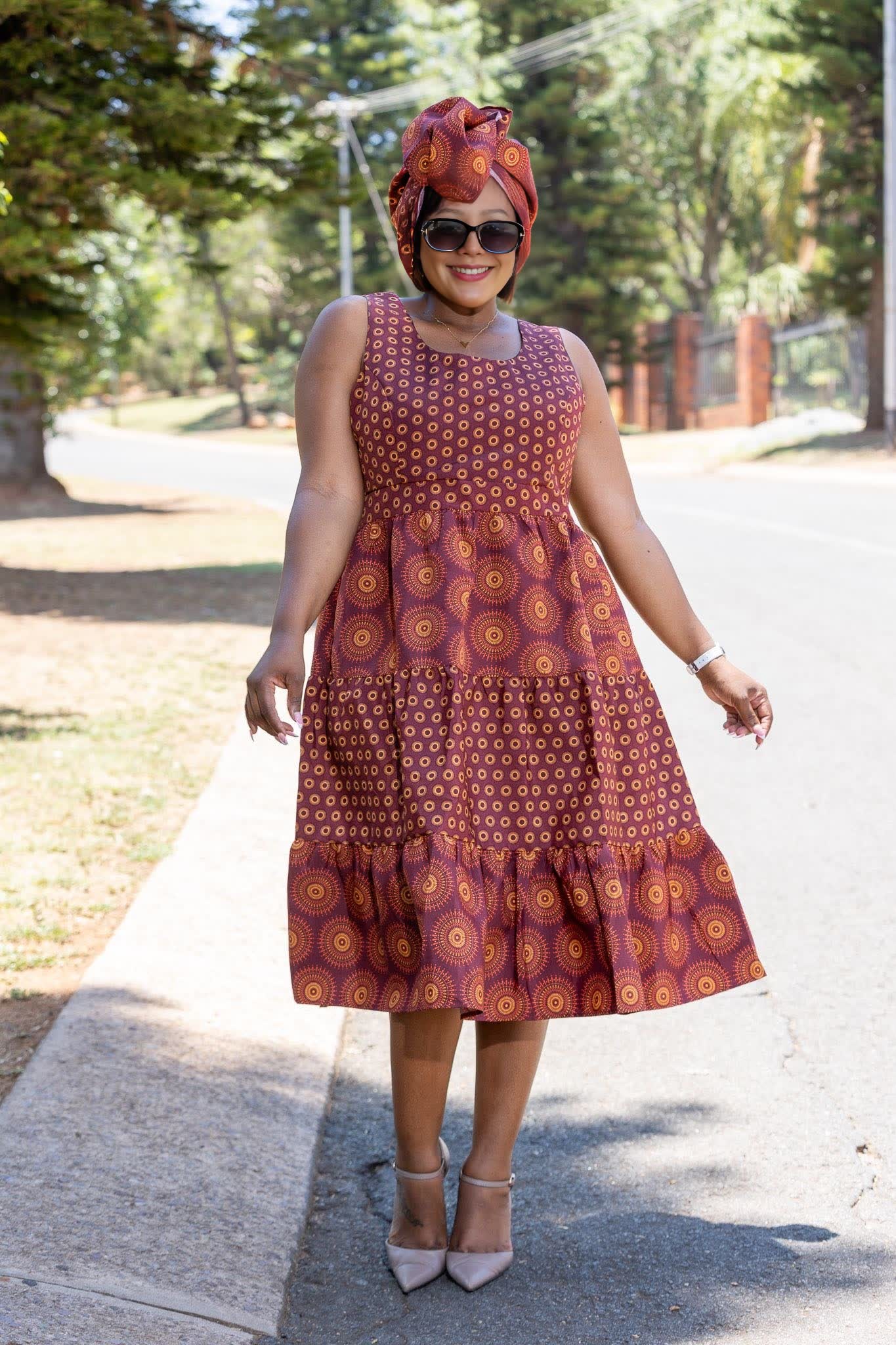 Ethnic tiered dress with geometric motifs, sleeveless; burgundy and orange