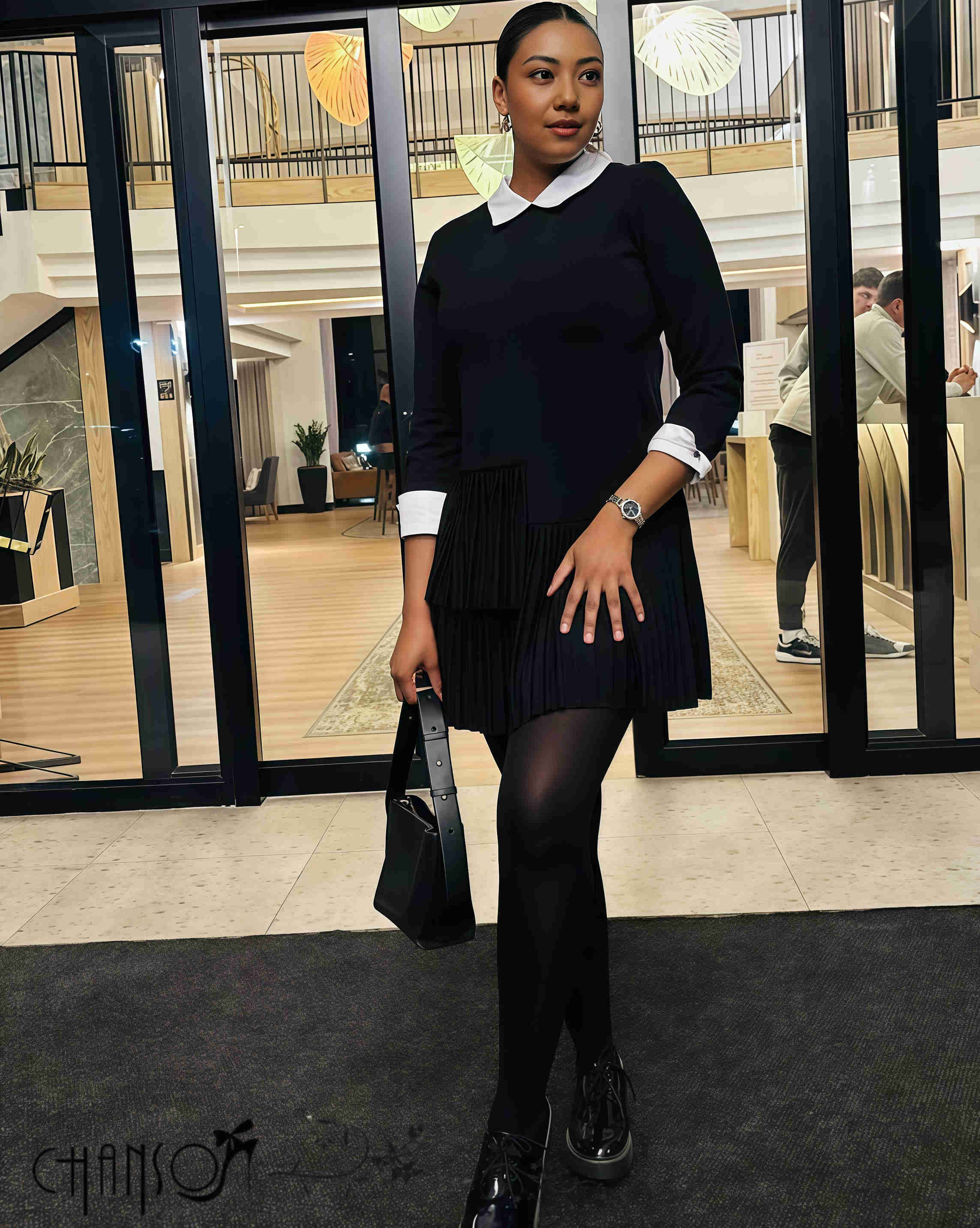 Pleated black midi dress with contrast white collar, long sleeves, gathered pleat skirt