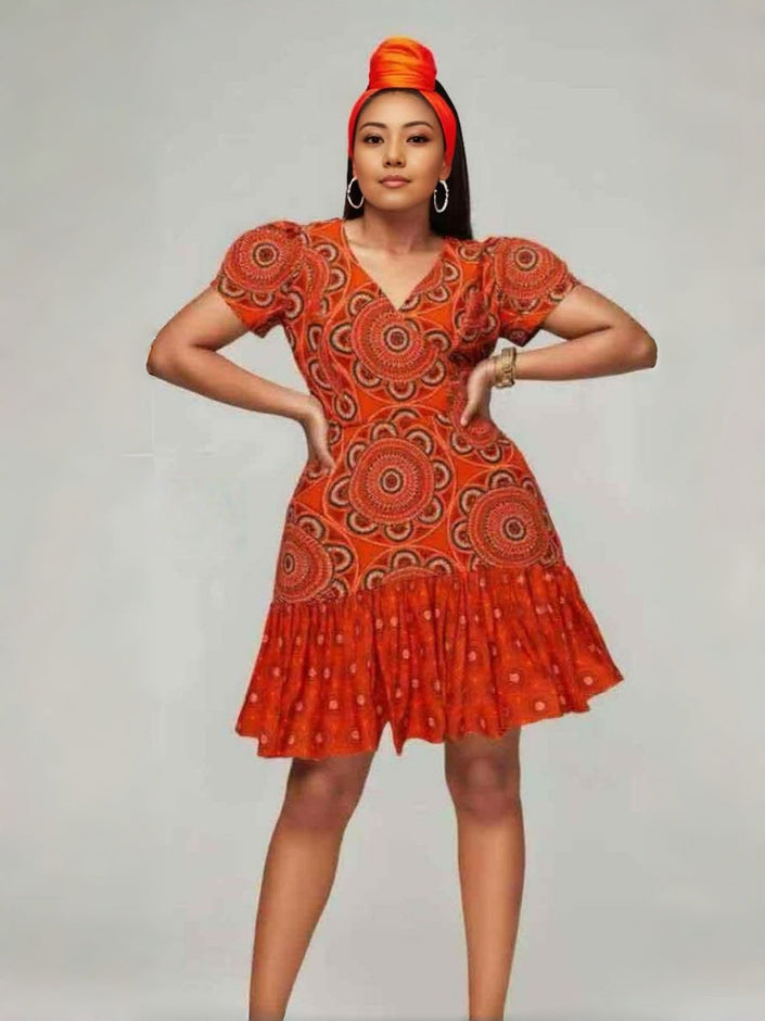Orange printed mini dress with puff sleeves, V-neck, and tiered skirt