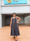 Dark sleeveless A-line maxi dress with light trim and scoop neck