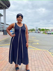 Dark sleeveless A-line maxi dress with light vertical trim and scoop neck