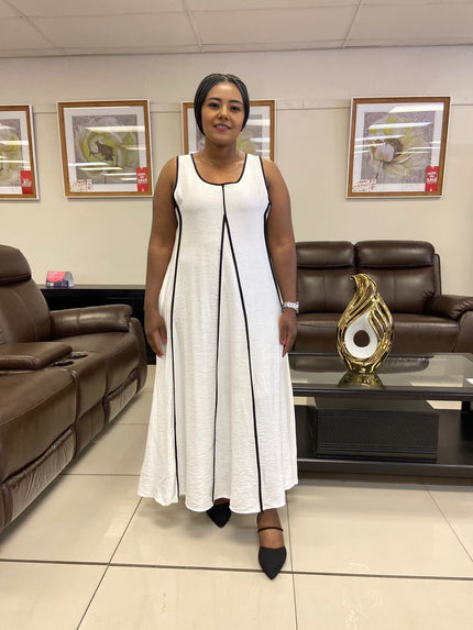 White sleeveless A-line maxi dress with black trim and scoop neck