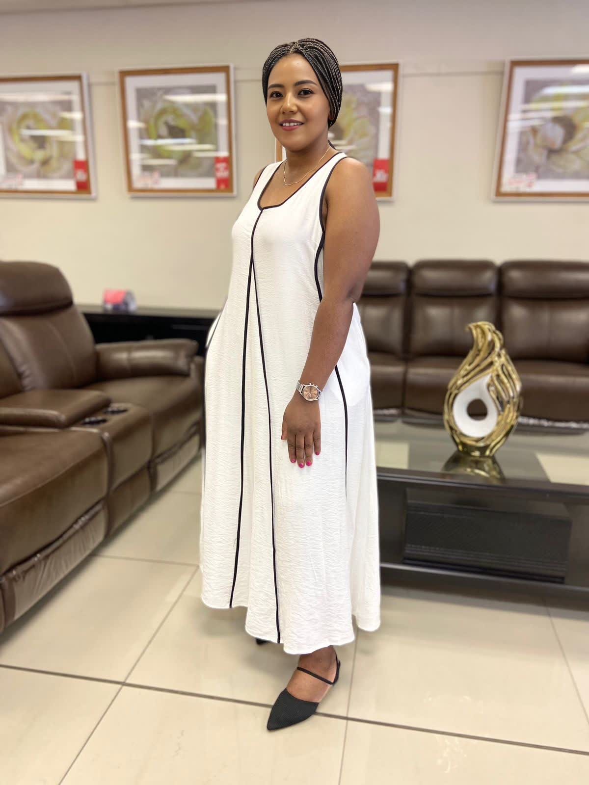 White sleeveless A-line maxi dress with black-trimmed neckline and long skirt