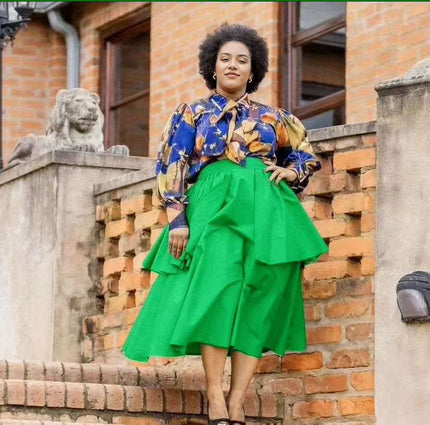 Floral puff-sleeve blouse with neck bow, paired with green tiered skirt