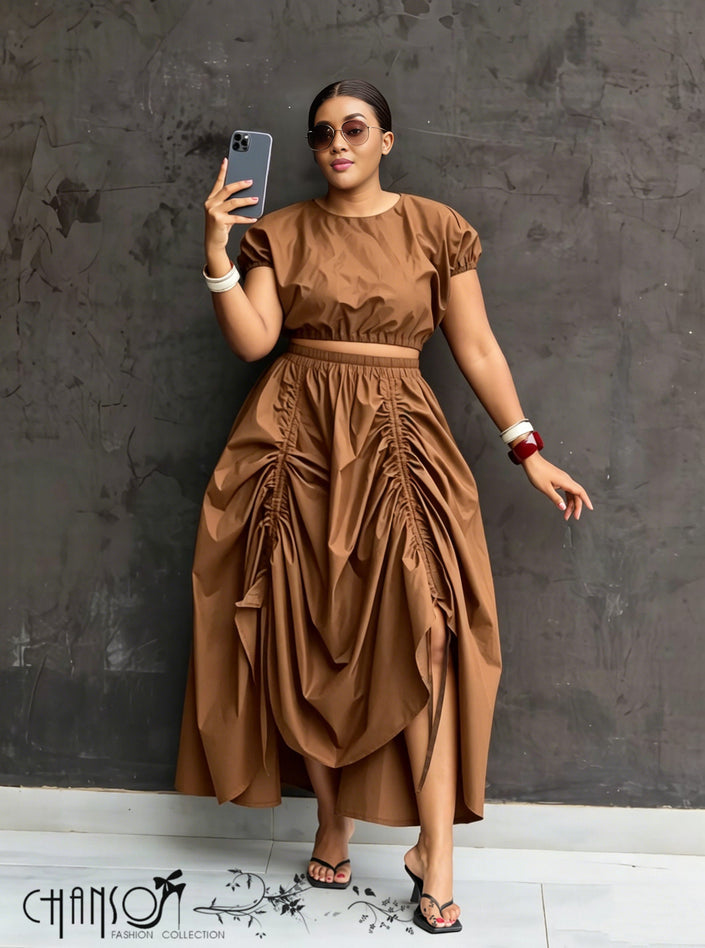 Tan maxi skirt with ruched waist and gathered, draped panels with side opening