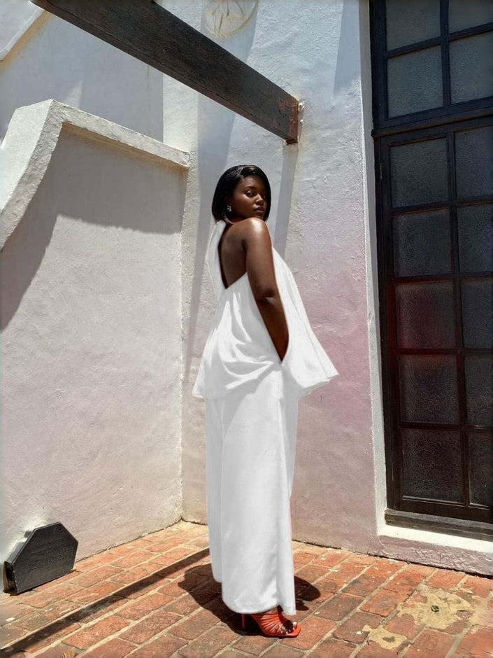 White sleeveless twin set top and wide-leg pants, draped open-back design