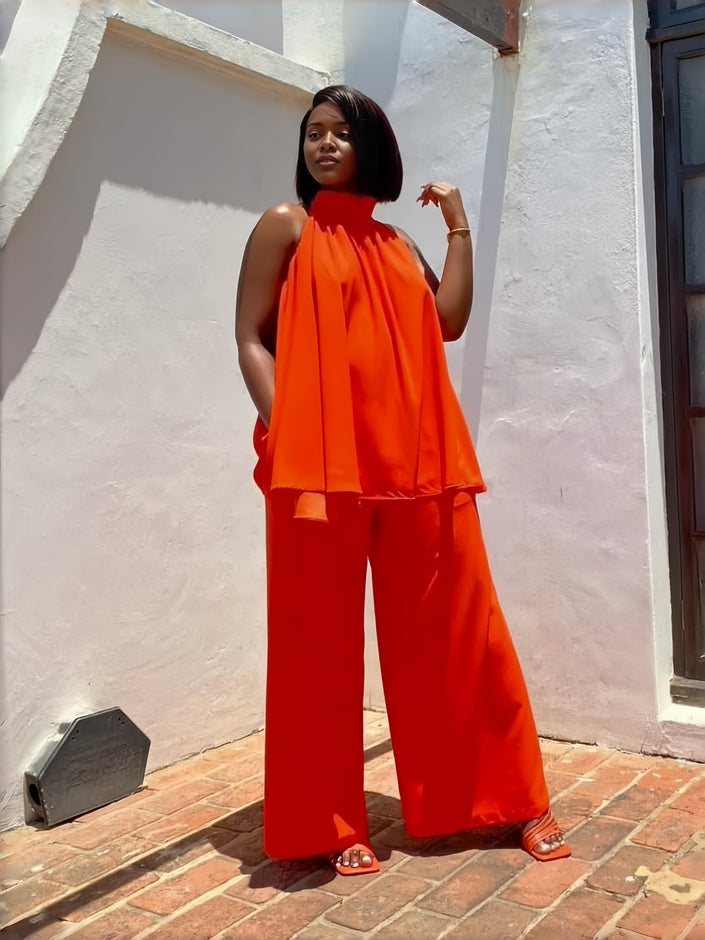 Orange-red sleeveless twin set top and wide-leg pants, layered ruffle hem