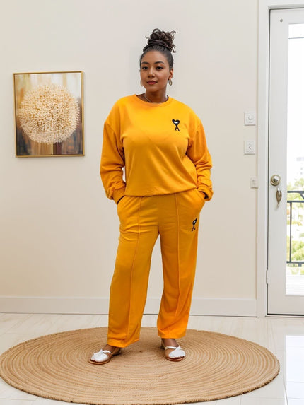 Orange-red two-piece jogger set with crewneck sweatshirt and matching loose pants