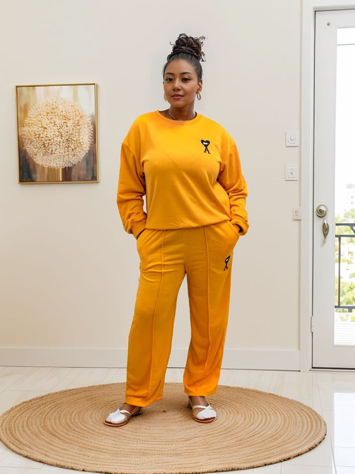 Orange-red two-piece jogger set with crewneck sweatshirt and matching loose pants