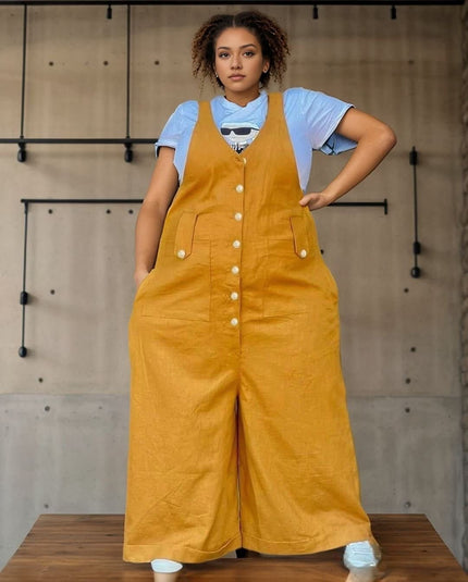 Yellow loose jumpsuit with adjustable bib straps, front buttons, and wide legs