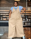 Beige loose jumpsuit with center buttons, chest pockets, and wide legs