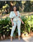 Light blue printed jumpsuit with puff sleeves, V-neck, and wide cropped legs