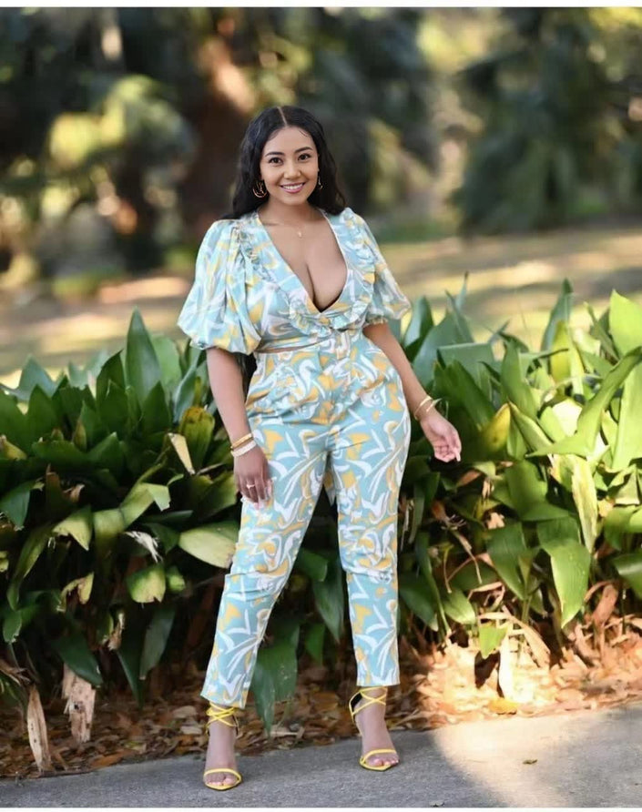 Light blue printed jumpsuit with puff sleeves, V-neck, and wide cropped legs